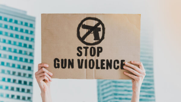 Image of sign with the words stop gun violence and a picture representing no guns.