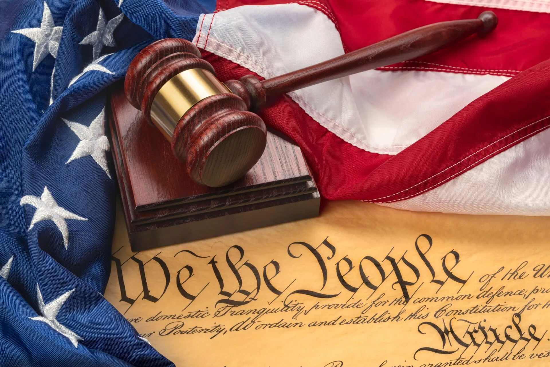 American,Flag,Draped,Around,A,Judge's,Gavel,Block,And,The