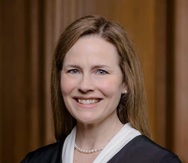 Portrait of a smiling woman in professional attire at NYCLA event.