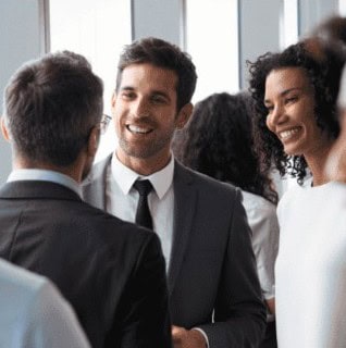 Group of diverse professionals at NYCLA event smiling and talking.